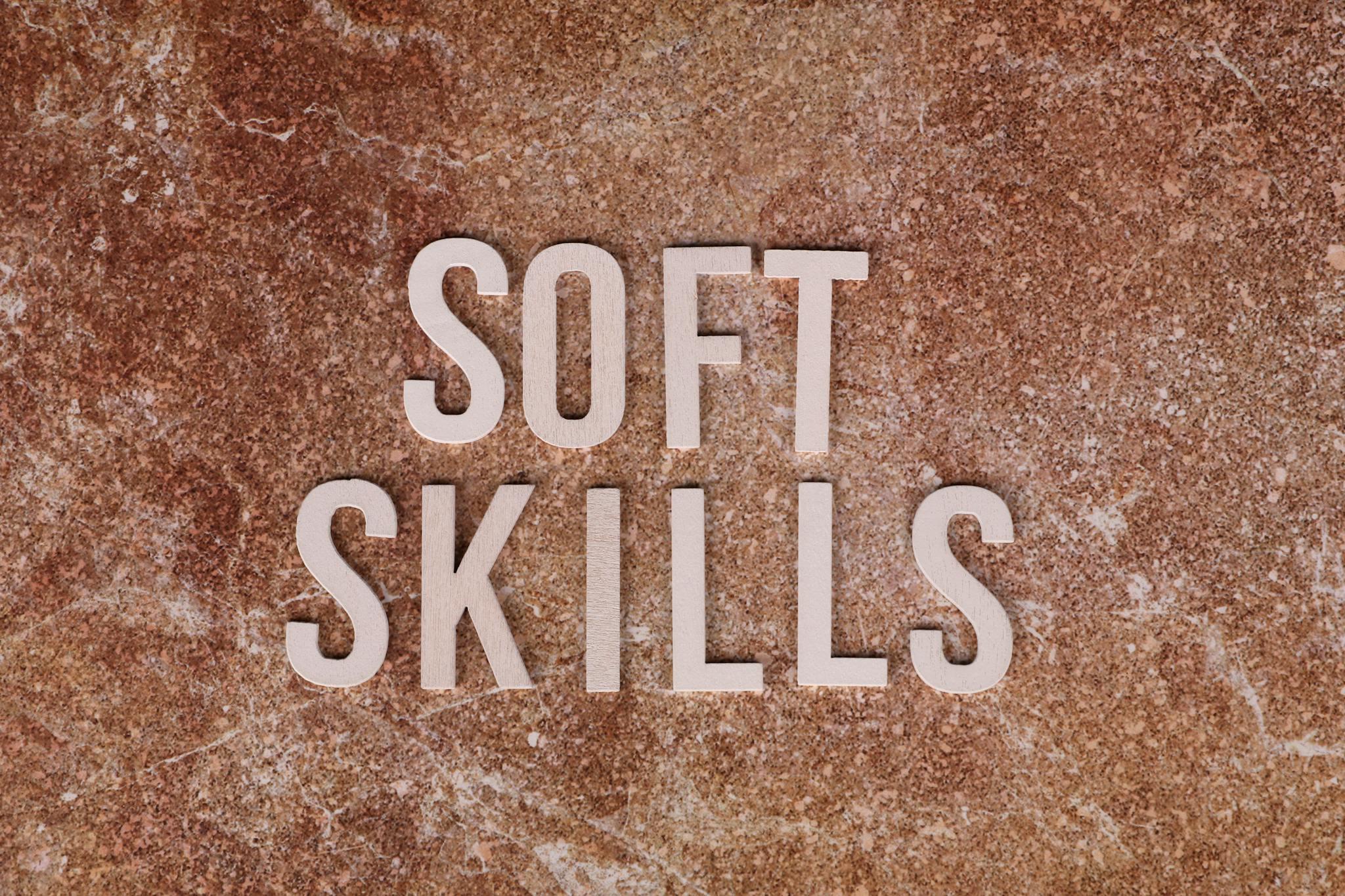 Close-up of the words 'Soft Skills' on a textured stone background for presentations or articles.